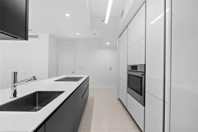 a kitchen with a sink stove and refrigerator