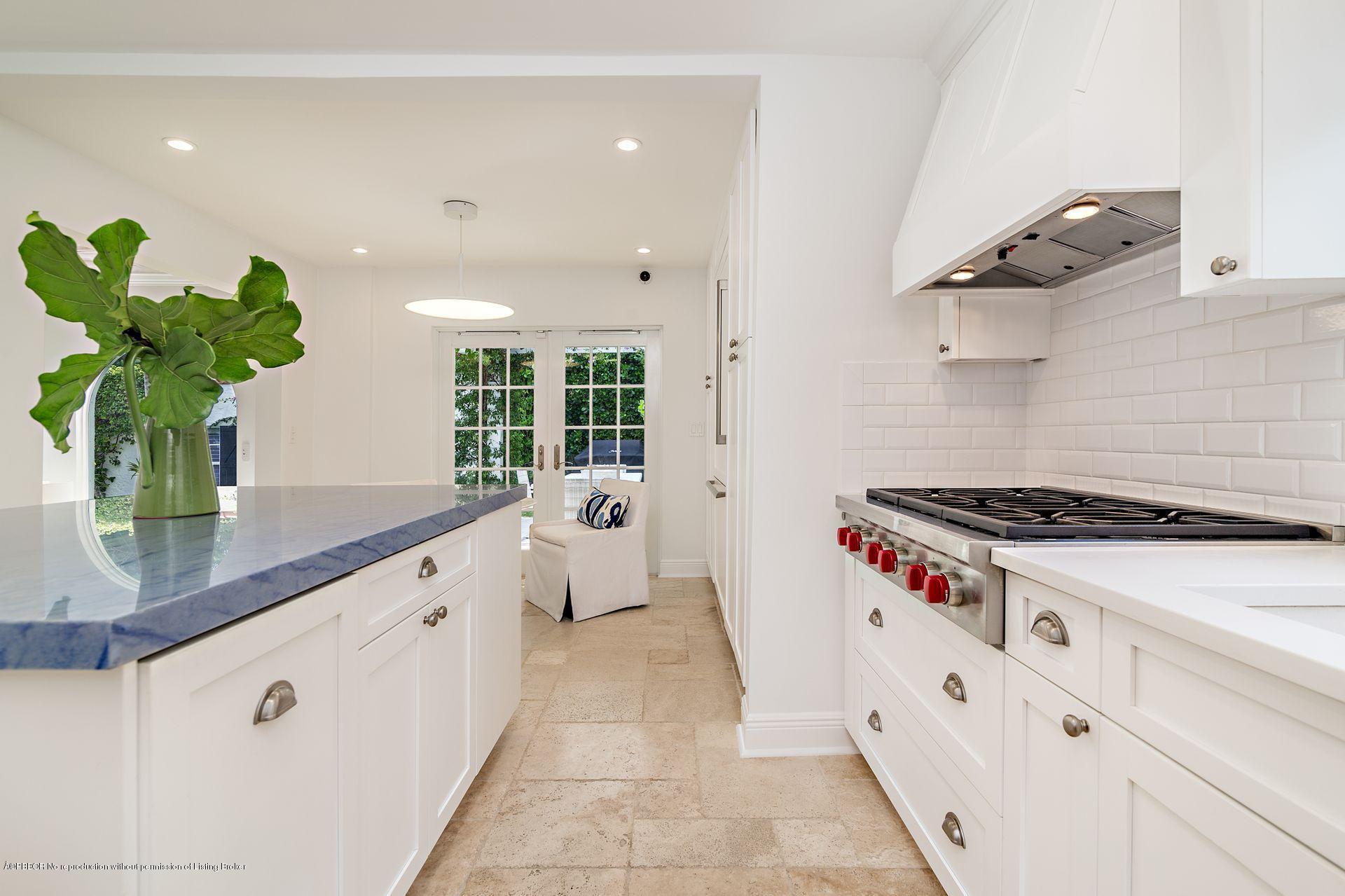 194 Pershing Way West Palm Beach, FL 33401 - Photo 11 of 50 a kitchen with white cabinets a stove and a window