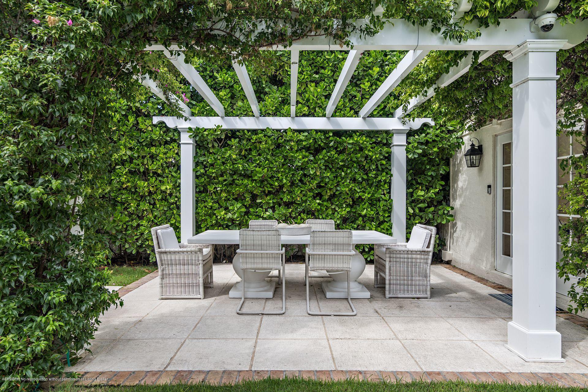 194 Pershing Way West Palm Beach, FL 33401 - Photo 12 of 50 a view of a patio with table and chairs and potted plants