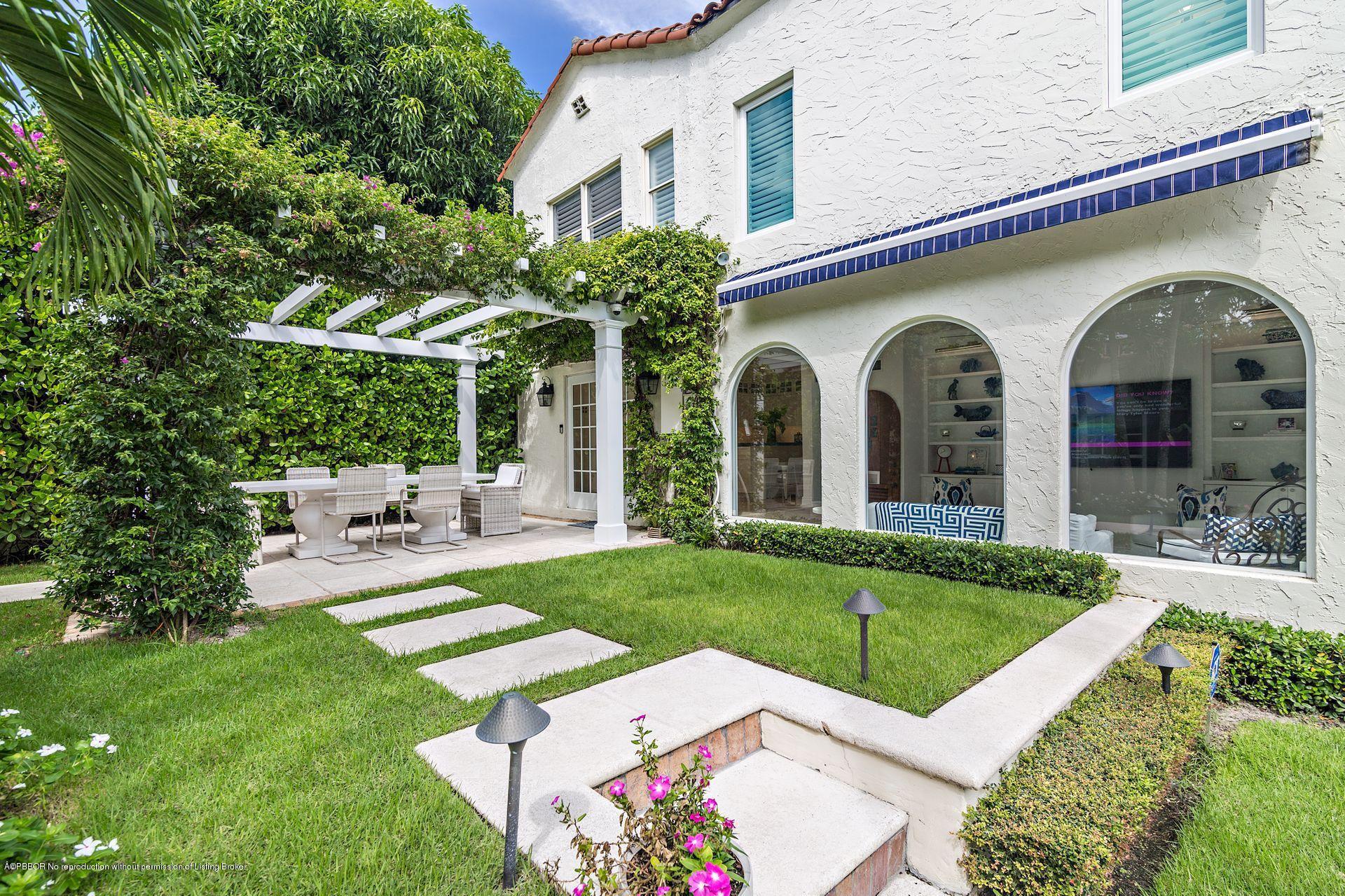 194 Pershing Way West Palm Beach, FL 33401 - Photo 13 of 50 a front view of a house with garden and porch