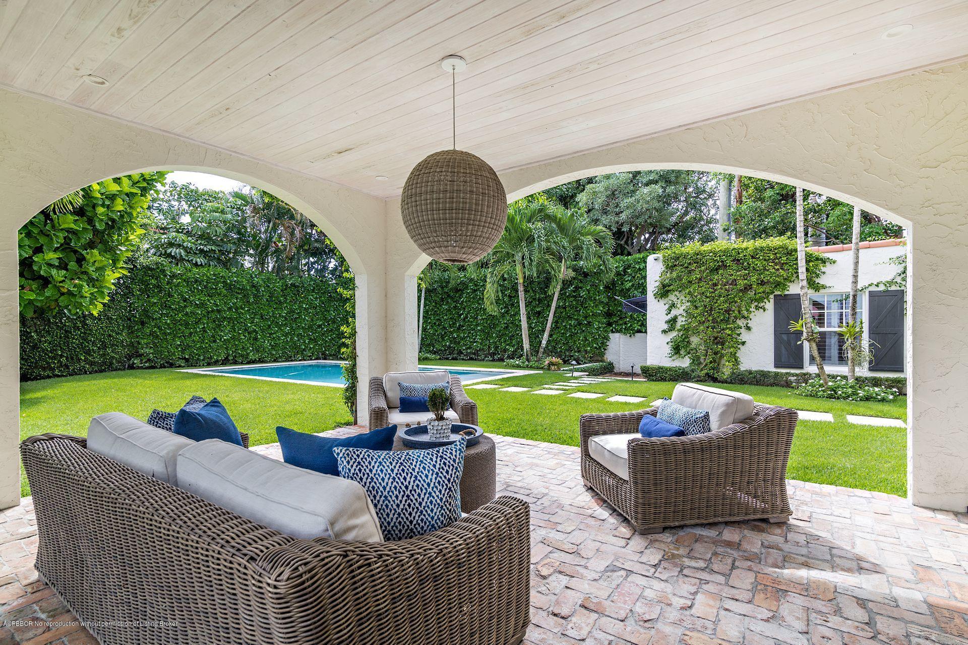 194 Pershing Way West Palm Beach, FL 33401 - Photo 16 of 50 a view of a swimming pool and a table and chairs in the garden
