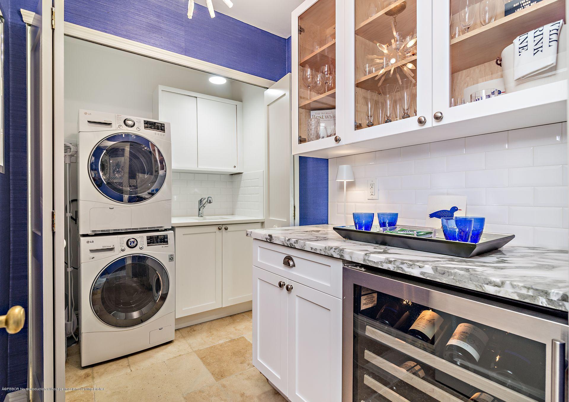 194 Pershing Way West Palm Beach, FL 33401 - Photo 18 of 50 a utility room with stainless steel appliances granite countertop a sink and a washer dryer