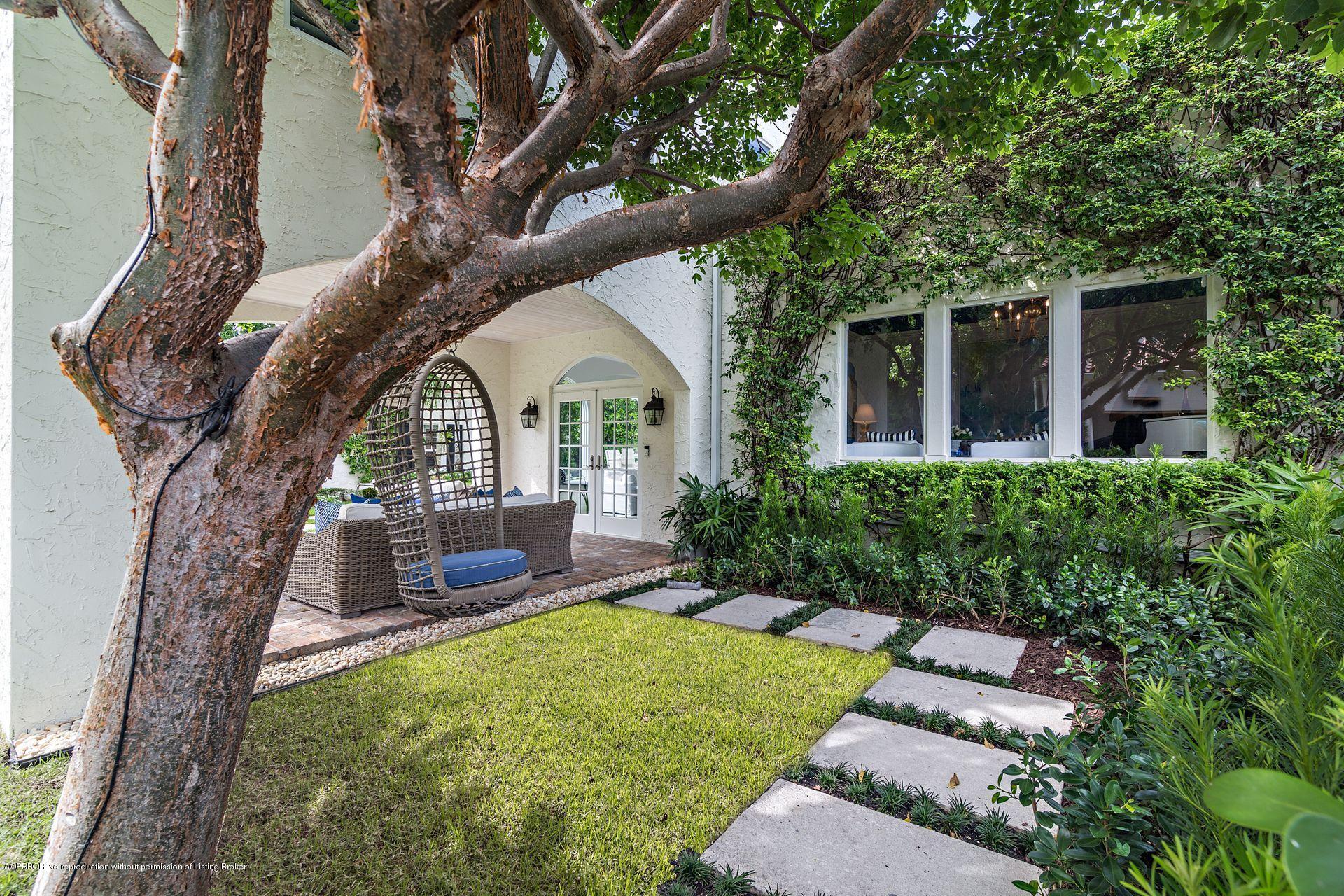 194 Pershing Way West Palm Beach, FL 33401 - Photo 32 of 50 a view of a house with a yard and sitting area