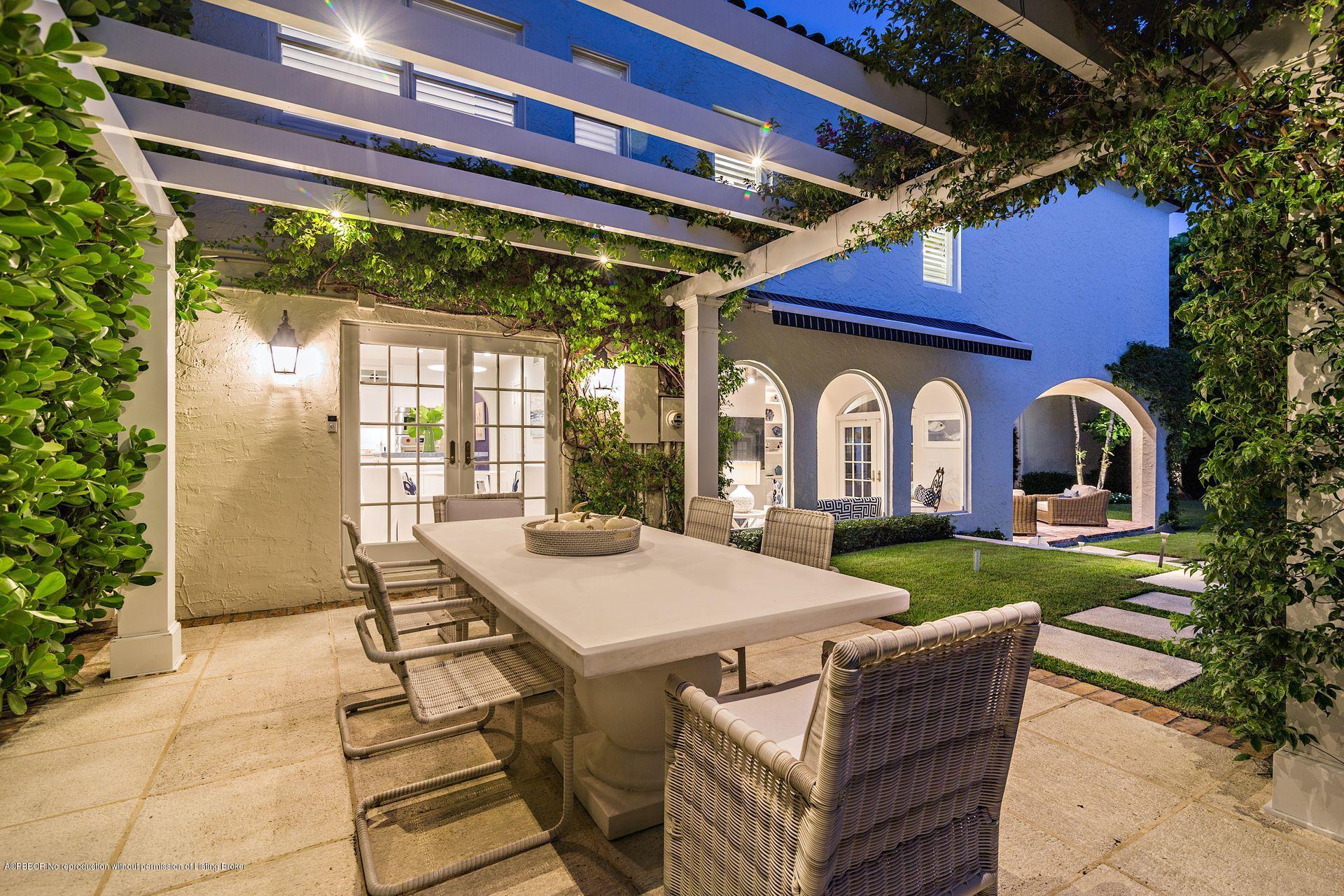 194 Pershing Way West Palm Beach, FL 33401 - Photo 40 of 50 a view of a patio with table and chairs and potted plants