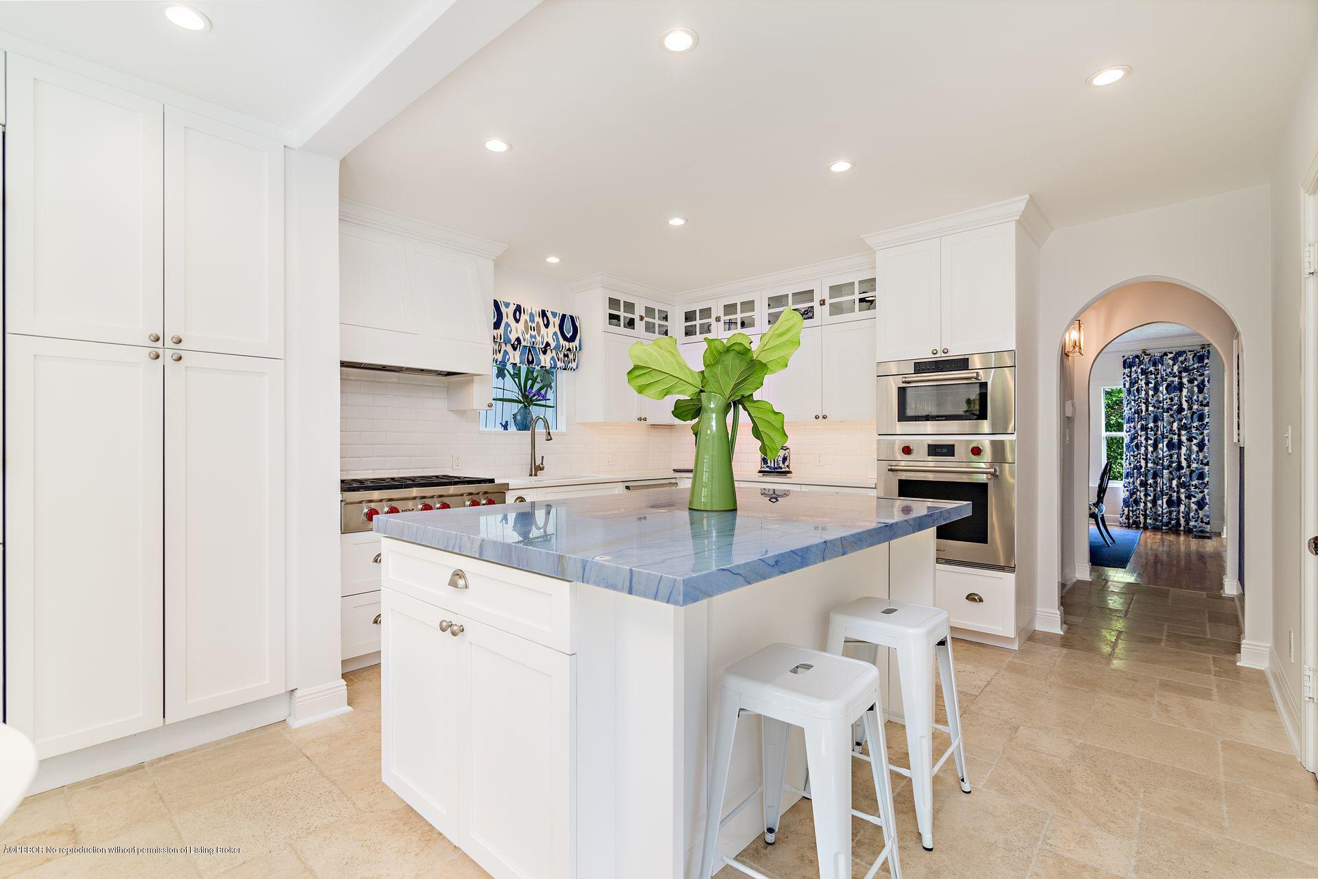194 Pershing Way West Palm Beach, FL 33401 - Photo 10 of 50 a kitchen with stainless steel appliances kitchen island granite countertop a table and chairs in it