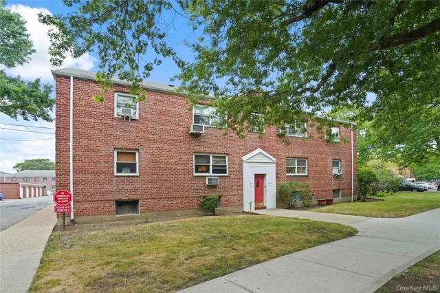 front view of a house next to a yard