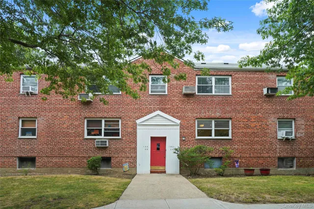 a front view of a house with a garden and plants