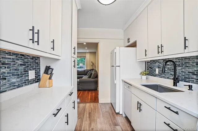 a kitchen with refrigerator and cabinets