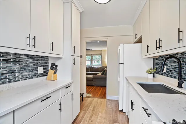 a kitchen with stainless steel appliances a sink dishwasher stove and refrigerator