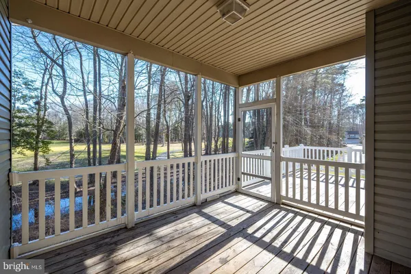 a view of balcony with wooden floor and fence