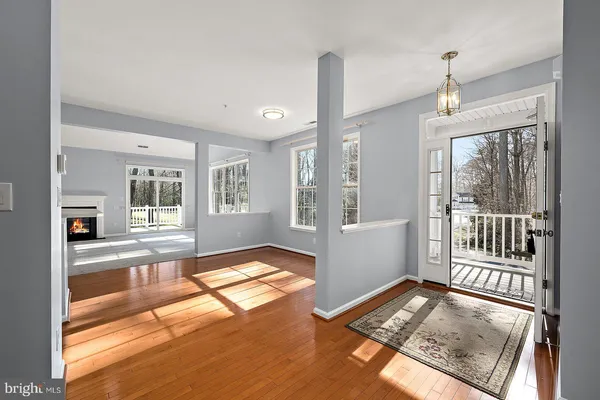 a view of an empty room with a fireplace and a window