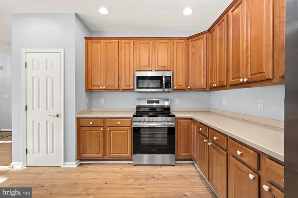 a kitchen with a sink and wooden cabinets