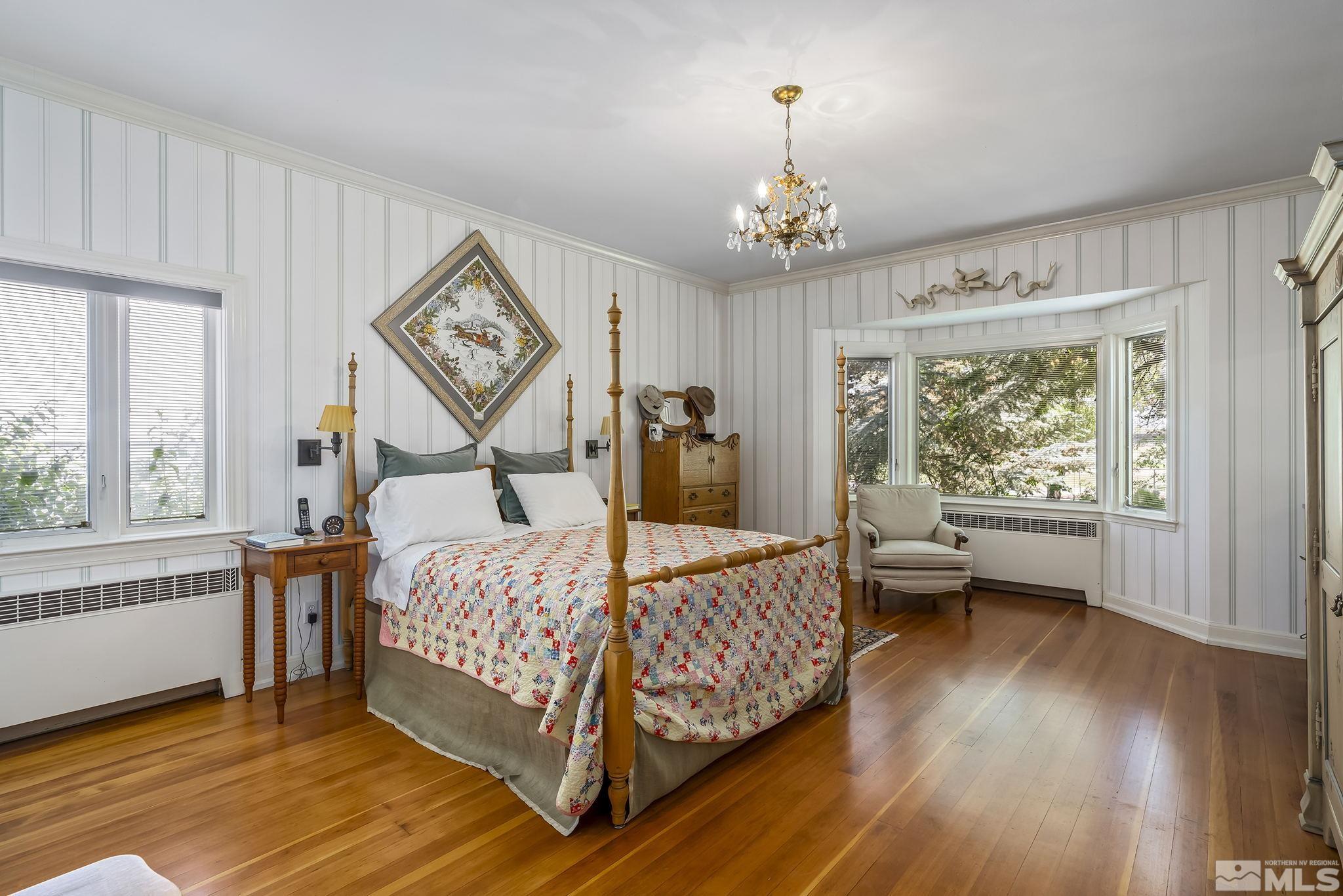 209 Urban Road Reno, NV 89509 - Photo 19 of 34 a bedroom with a bed and a chandelier