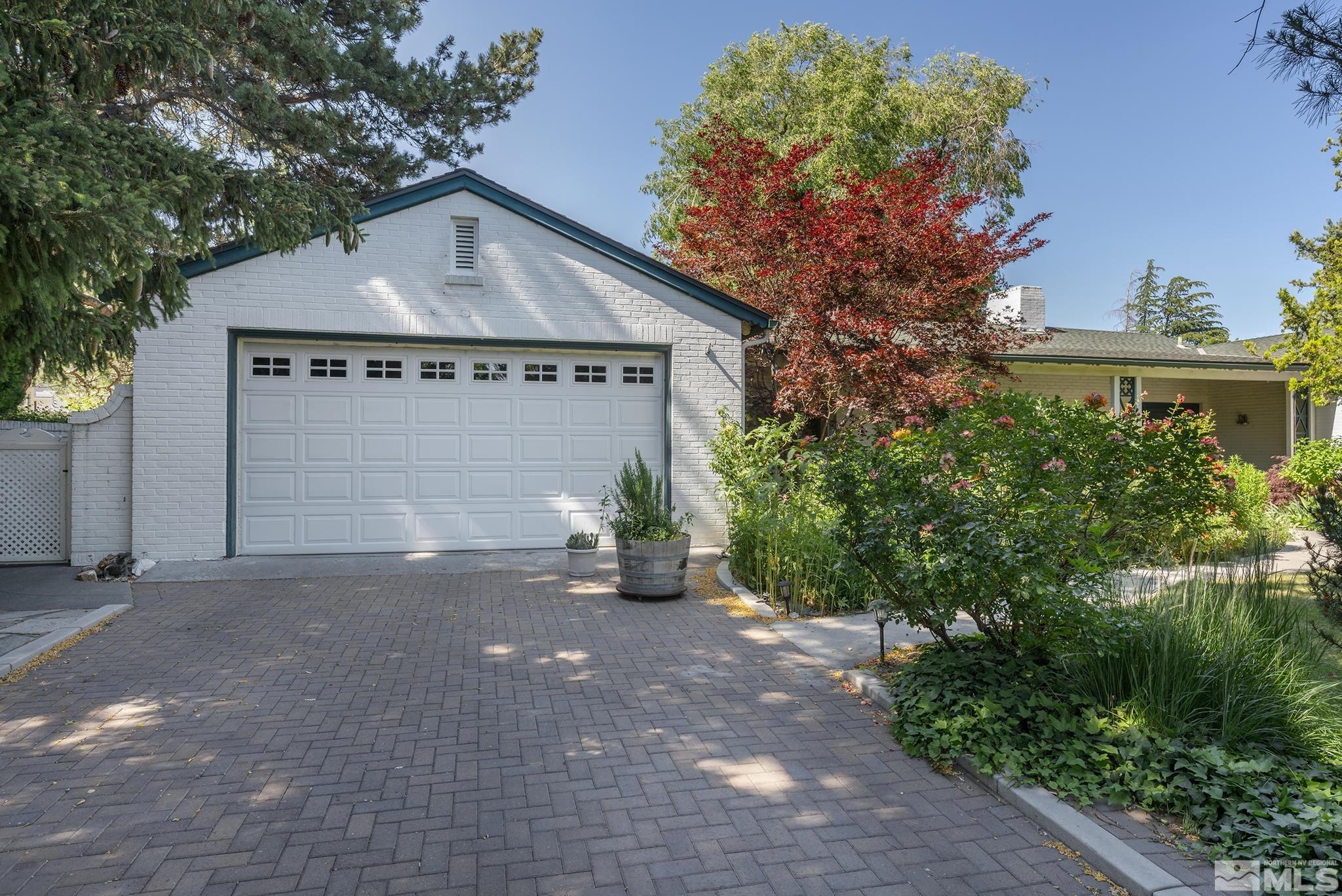 209 Urban Road Reno, NV 89509 - Photo 2 of 34 a front view of a house with a yard and garage