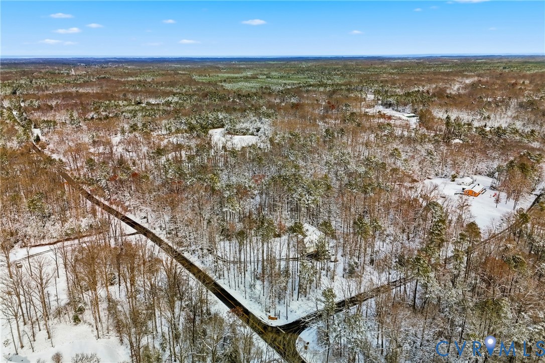 0 McClellan Road Mechanicsville, VA 23111 - Photo 5 of 14 Snowy aerial view featuring a wooded view
