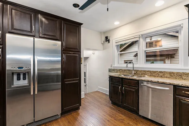 a kitchen with stainless steel appliances granite countertop a refrigerator and a sink
