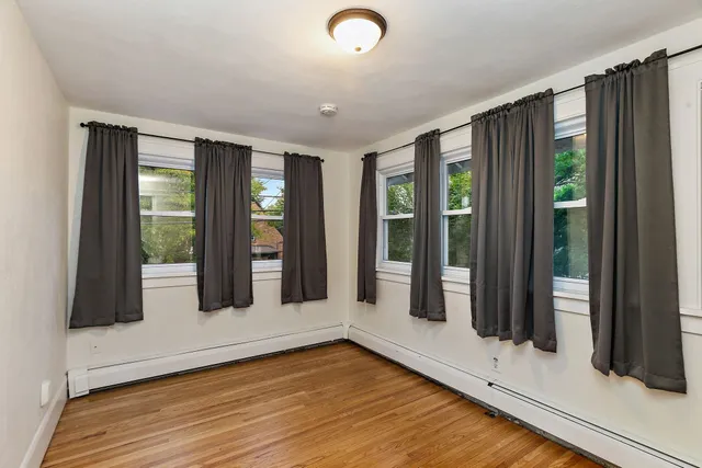a view of an entryway with wooden floor and door