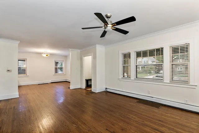 a view of a livingroom with wooden floor and window