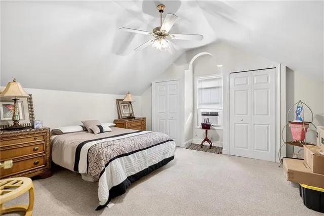 a bedroom with bed and white chandelier