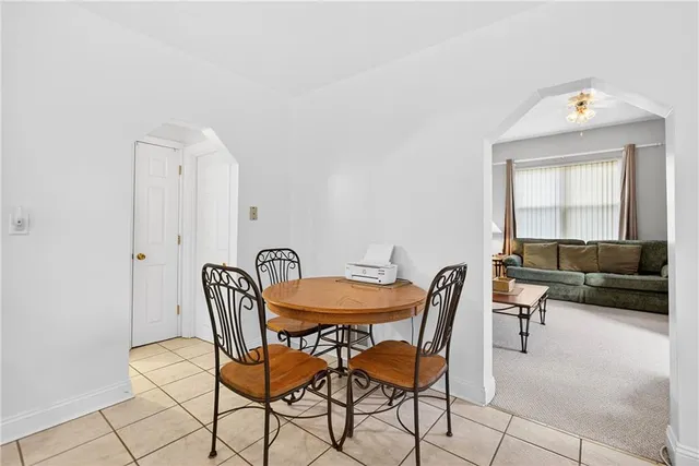 a view of a dining room with furniture and a potted plant