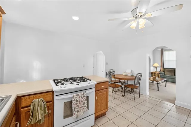 a kitchen with stainless steel appliances a stove a table and chairs