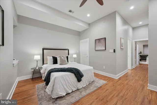 a bedroom with a bed and wooden floor