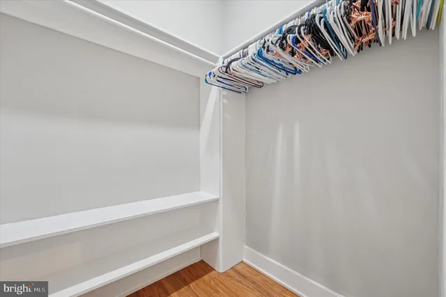 a view of walk in closet with empty racks
