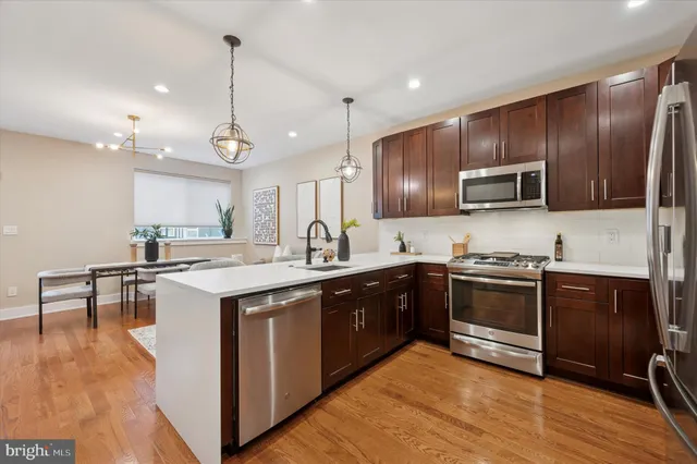 a kitchen with a sink stove and microwave