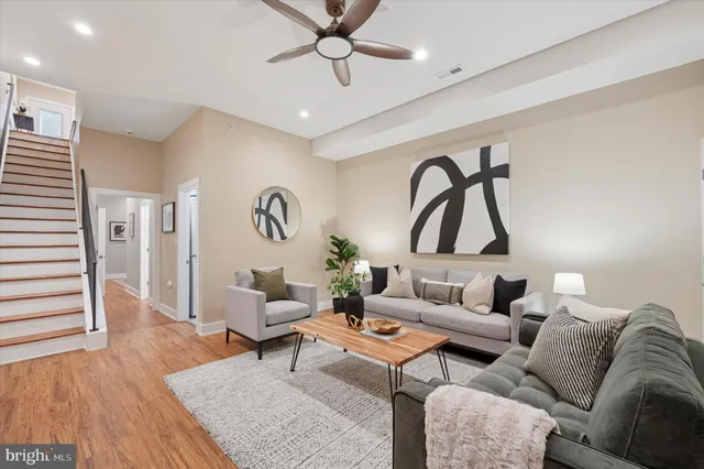 a living room with furniture and wooden floor