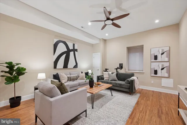 a living room with furniture and a wooden floor