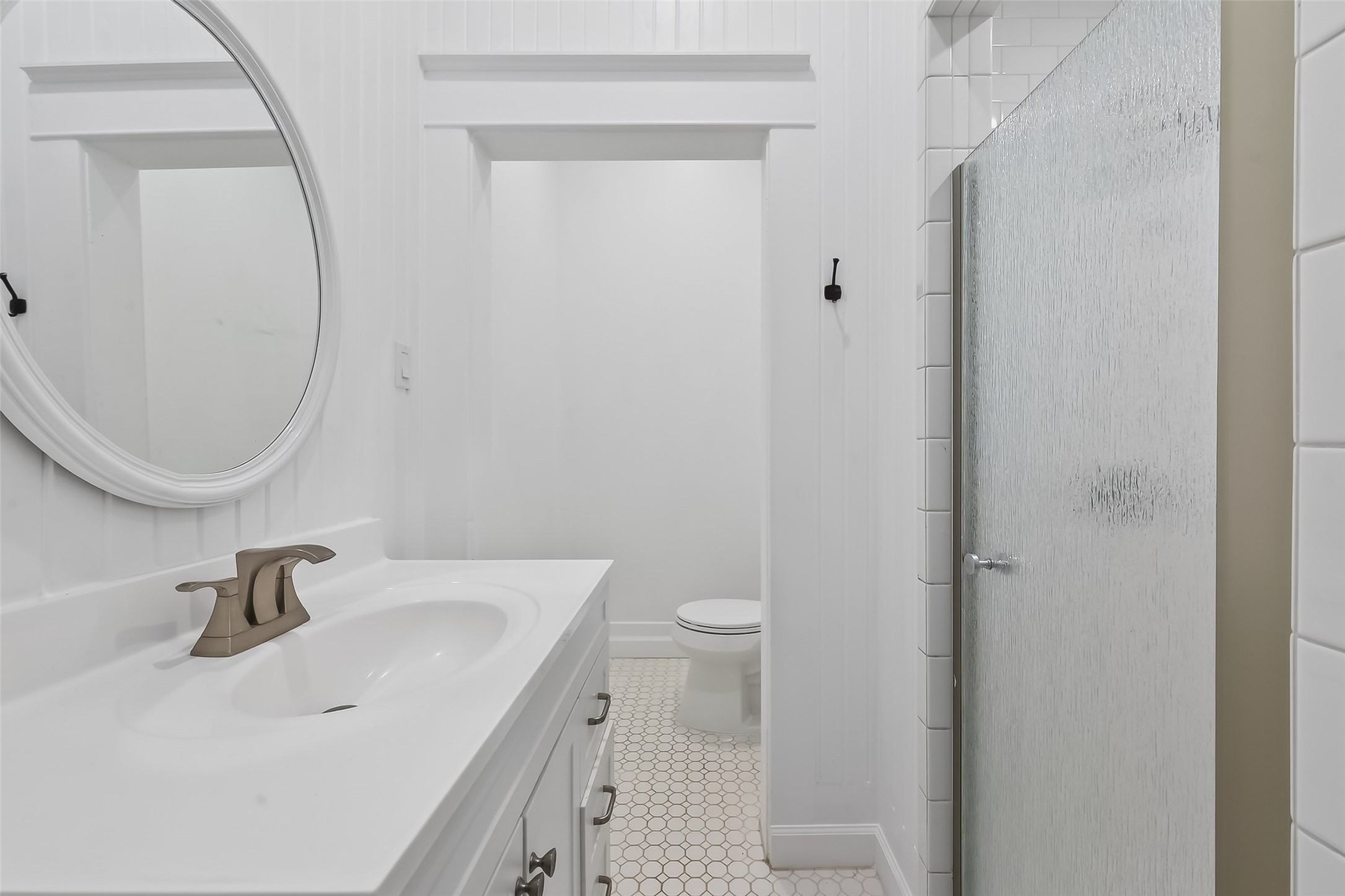 38011 Spur 149 Road Magnolia, TX 77354 - Photo 33 of 50 This secondary bathroom exudes farmhouse charm with its classic design, offering a serene and timeless appeal.