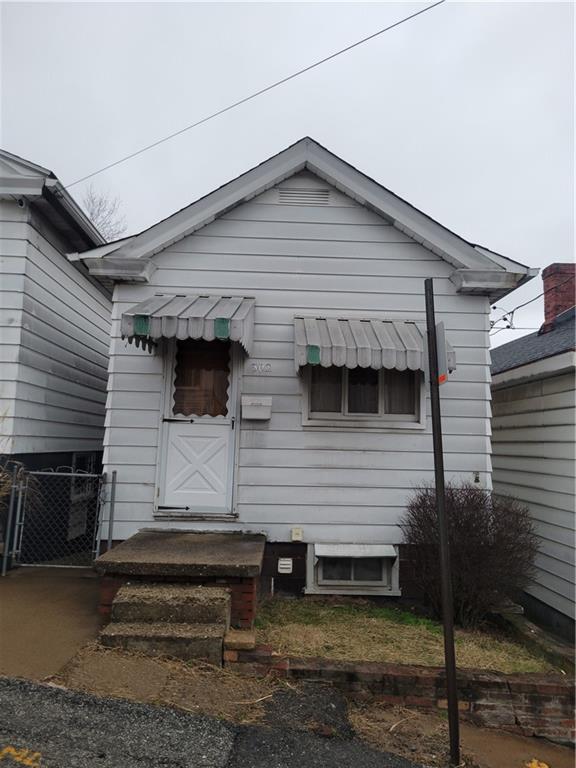 302 Laurel Street McKees Rocks, PA 15136 - Photo 1 of 3 a front view of a house with a yard