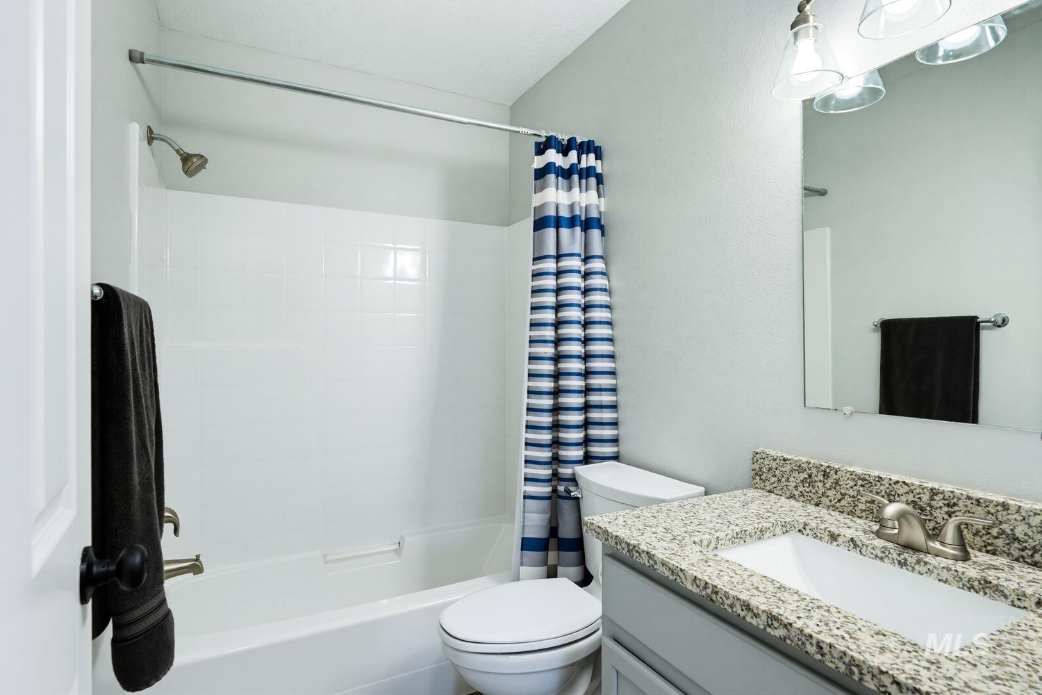 5221 Lockwood Way Caldwell, ID 83607 - Photo 20 of 27 White tub and shower combination with a curved shower rod