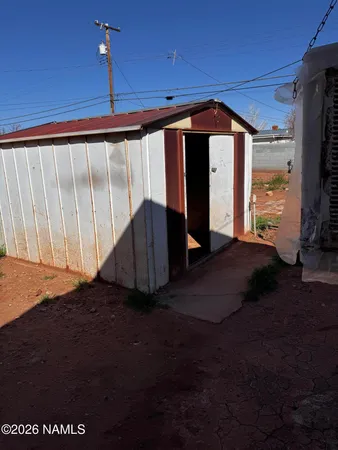 a view of an empty room with a fireplace and a window