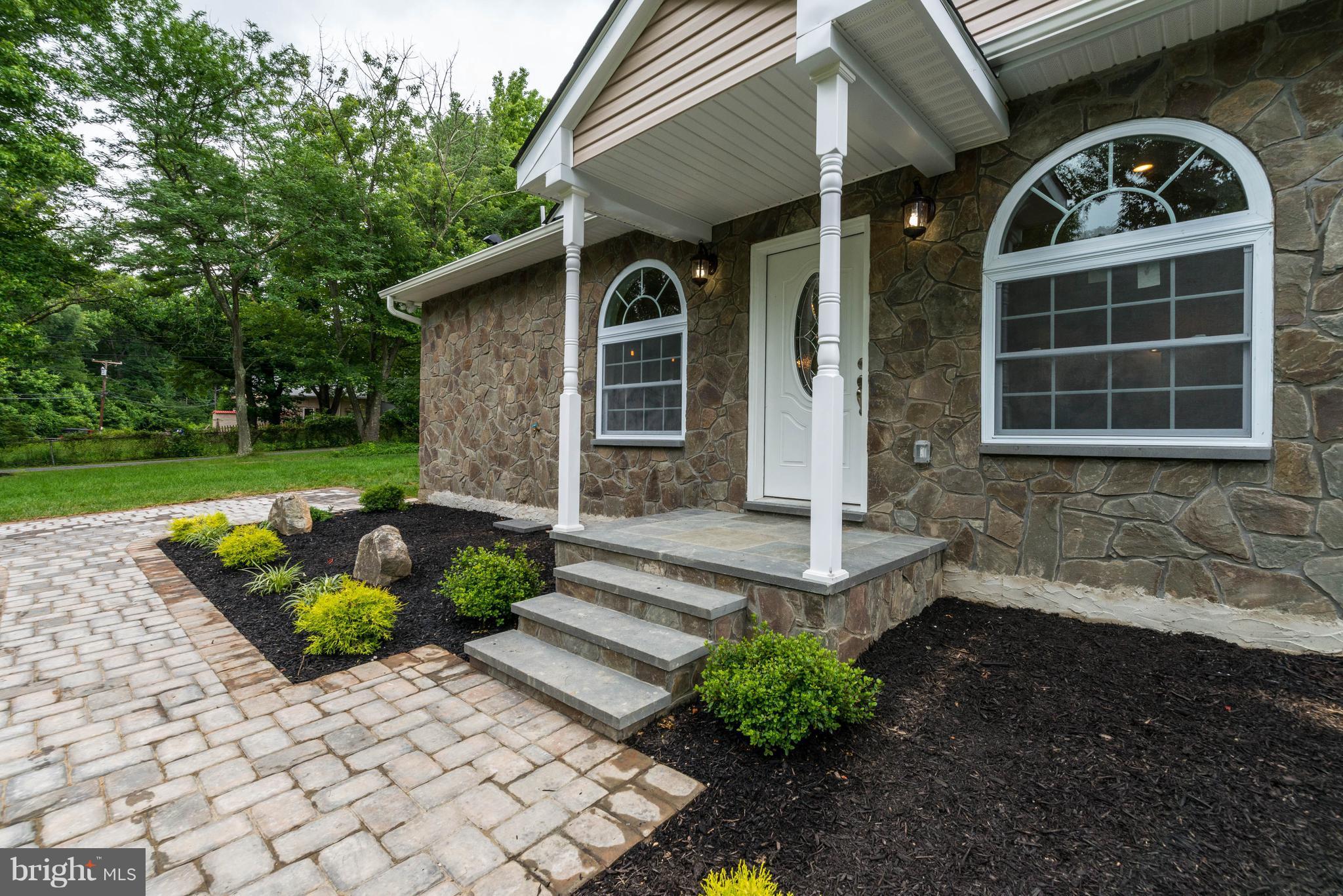 8220 Mission Road Jessup, MD 20794 - Photo 1 of 28 a front view of a house with garden