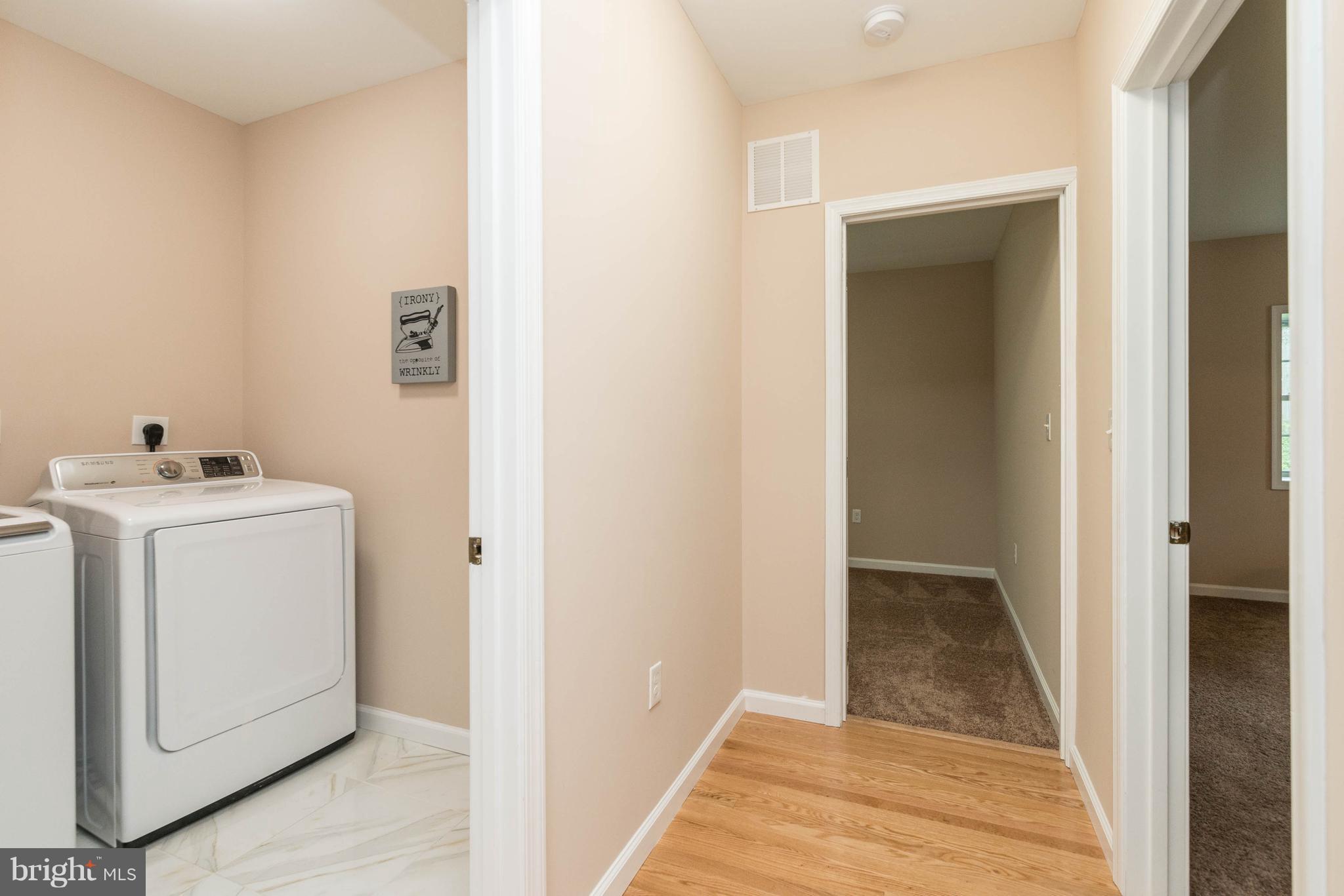 8220 Mission Road Jessup, MD 20794 - Photo 12 of 28 a view of storage and utility room with washer and dryer