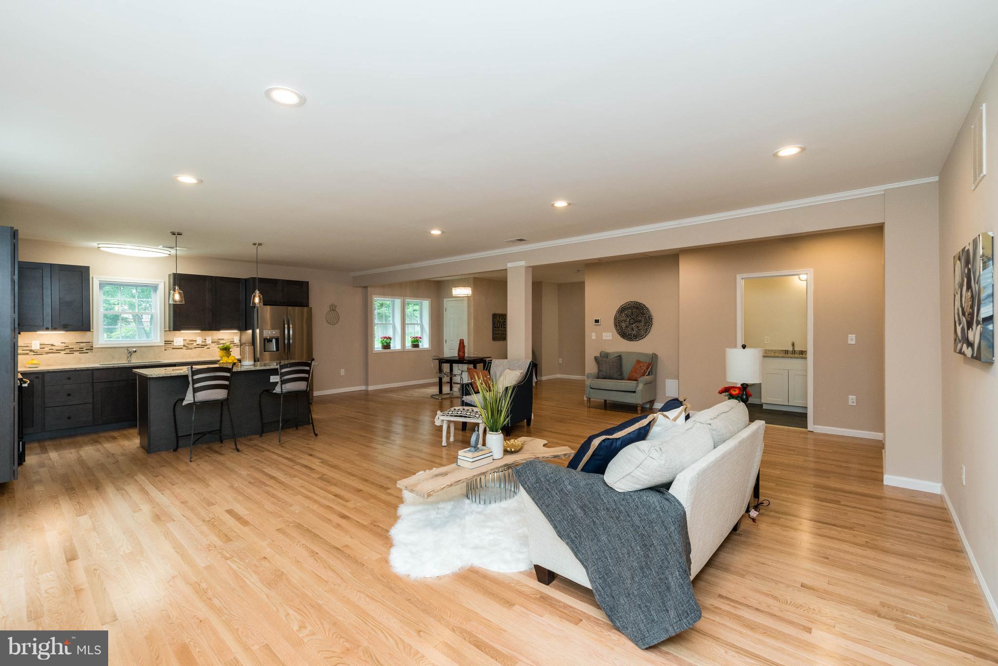 8220 Mission Road Jessup, MD 20794 - Photo 19 of 28 a living room with couches kitchen view and kitchen view
