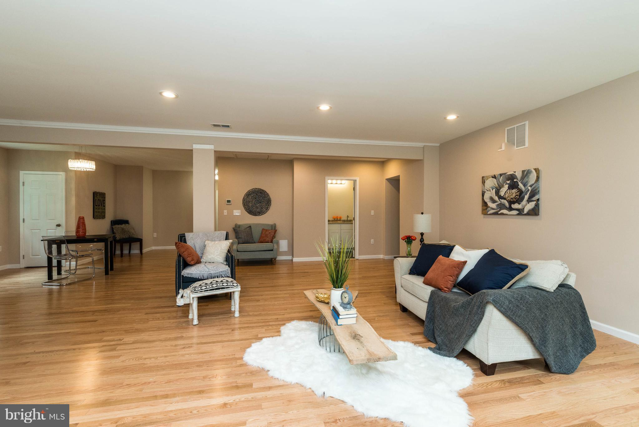 8220 Mission Road Jessup, MD 20794 - Photo 23 of 28 a living room with furniture and wooden floor