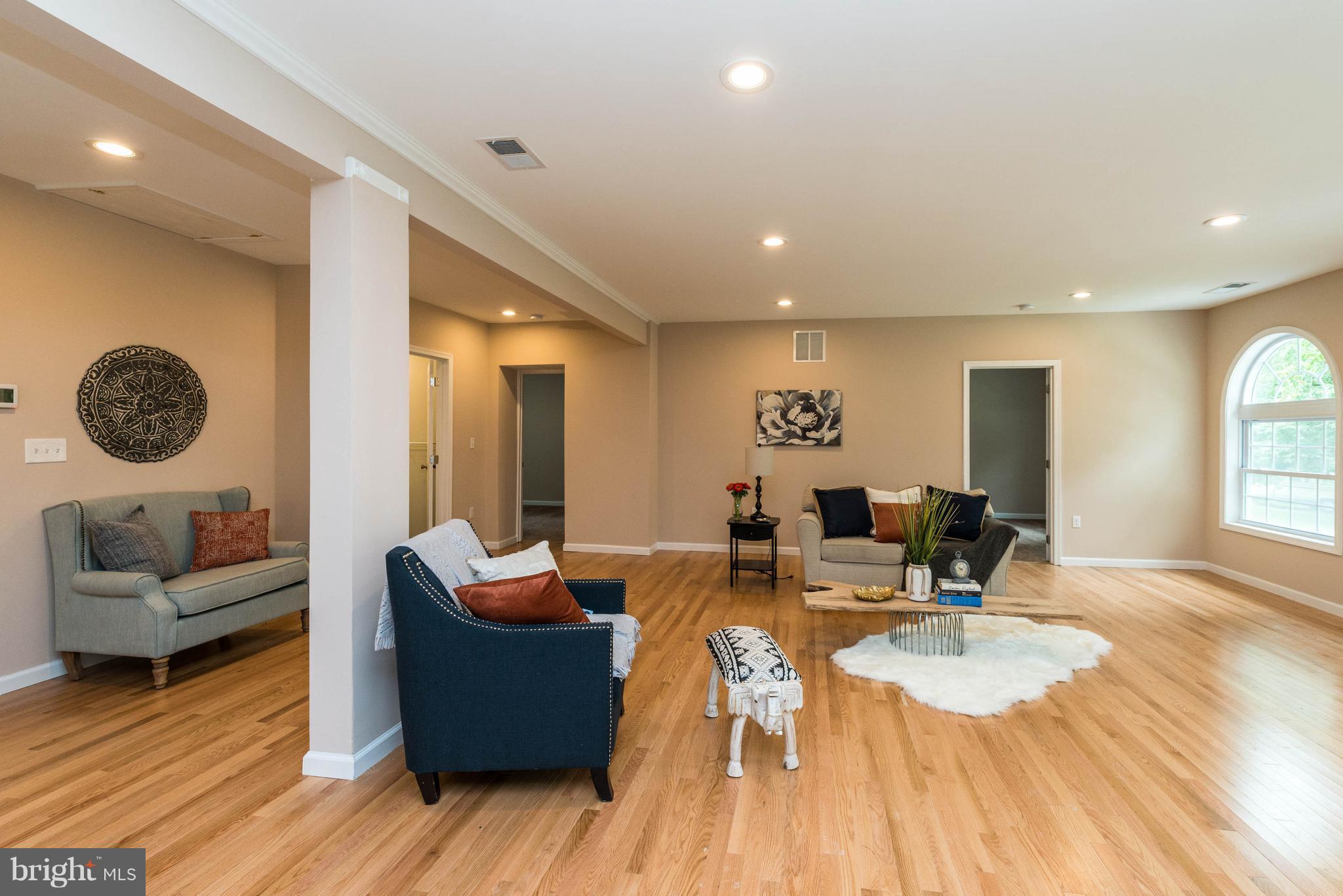 8220 Mission Road Jessup, MD 20794 - Photo 24 of 28 a living room with furniture and a wooden floor