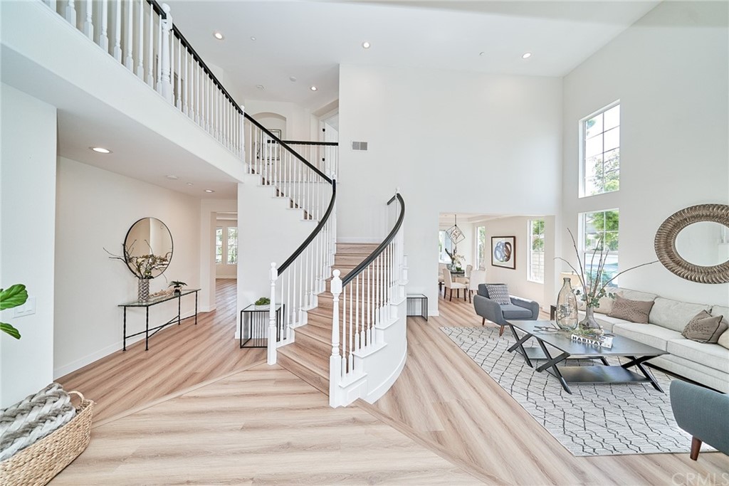 50 Lakeside Drive Buena Park, CA 90621 - Photo 19 of 69 a living room with furniture and a dining table with wooden floor