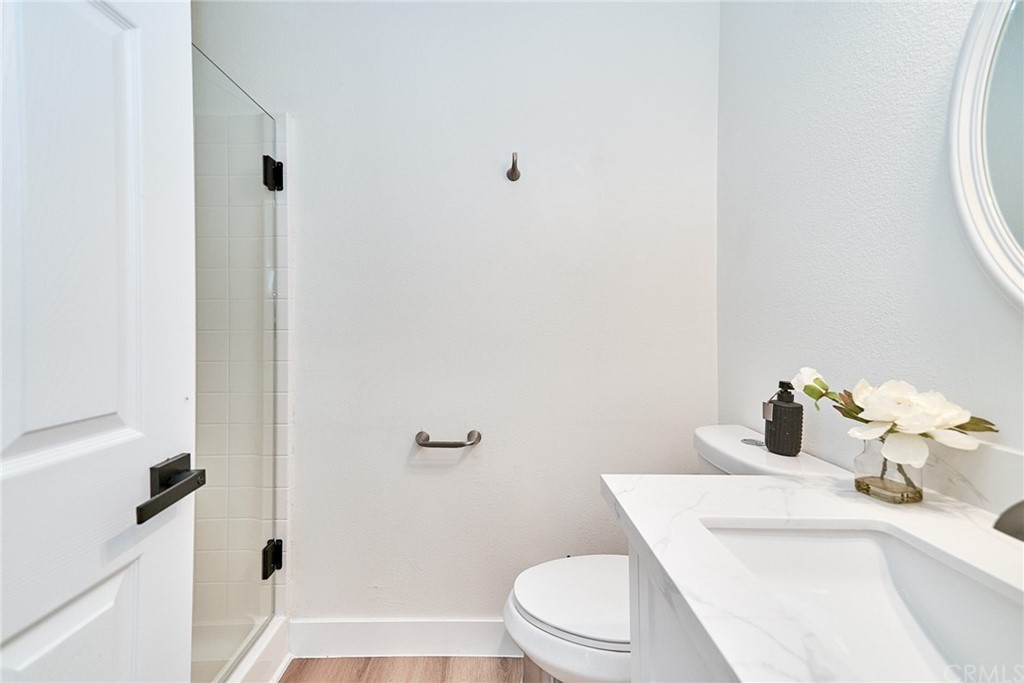 50 Lakeside Drive Buena Park, CA 90621 - Photo 36 of 69 a bathroom with a sink a toilet and shower curtain