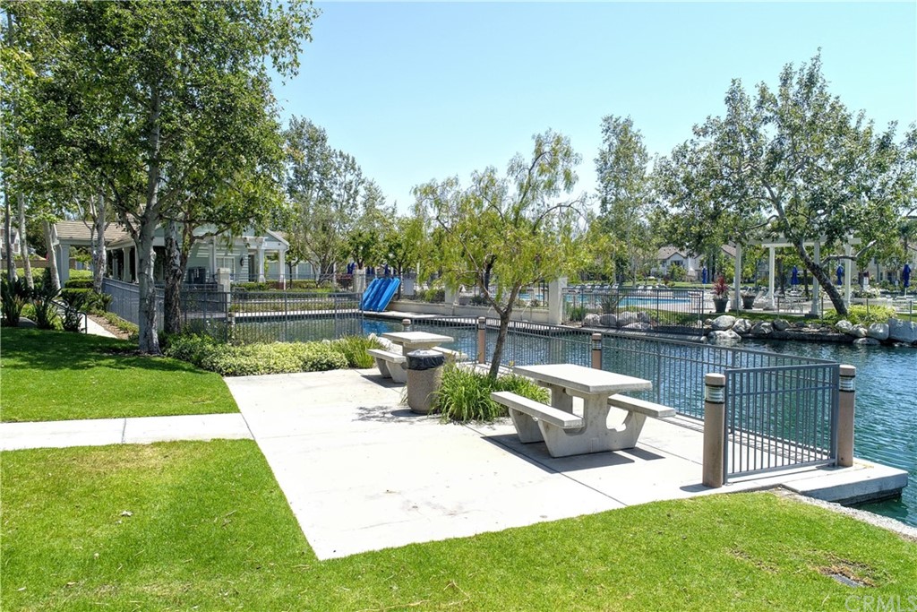 50 Lakeside Drive Buena Park, CA 90621 - Photo 68 of 69 a view of a patio with table and chairs potted plants and a large tree