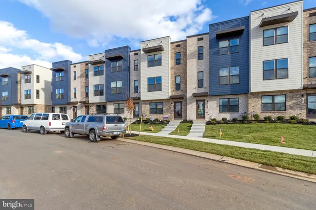 a view of a street with a cars parked in front of it