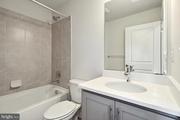a bathroom with a sink toilet tub and shower