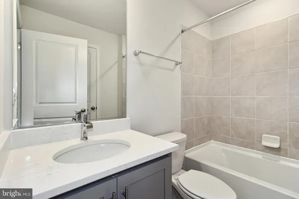 a bathroom with a sink toilet vanity and shower