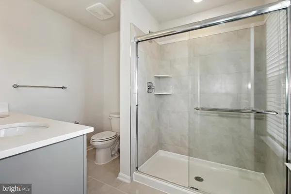 a bathroom with a shower a toilet and a sink