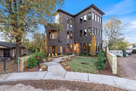 a front view of a residential apartment building with a yard