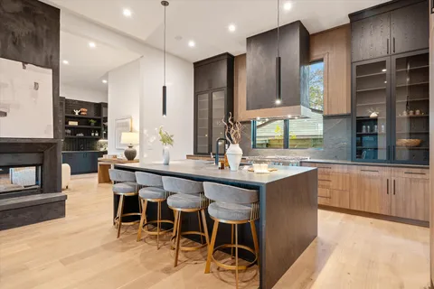 a kitchen with stainless steel appliances granite countertop a sink and a stove
