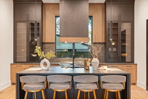 a kitchen with stainless steel appliances granite countertop a sink a stove and a refrigerator