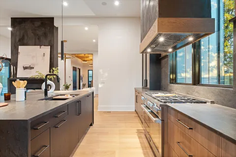 a kitchen with granite countertop stainless steel appliances and wooden cabinets